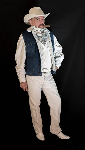 istock The cowboy with mustache in a white hat, smoking  cigar 626009242