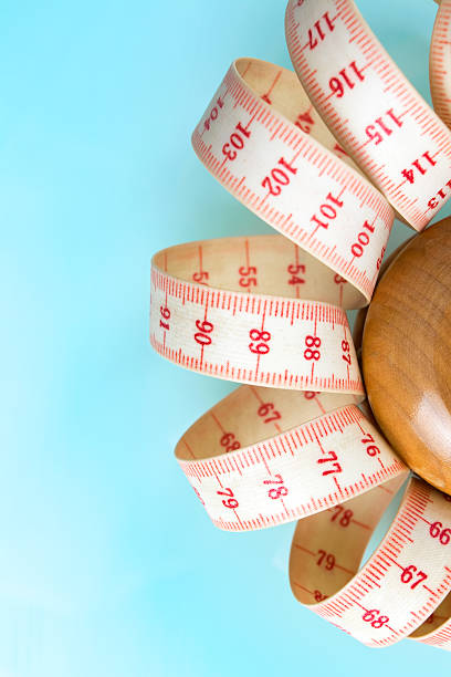 istock Yo-yo effect concept. Wooden yoyo with centimeter measure. 626009282