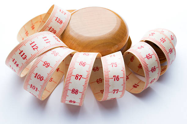 istock Yo-yo effect concept. Wooden yoyo with centimeter measure. 626009400