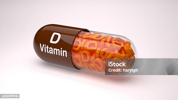 Brown Pill Or Capsule Filled With Vitamin D Stock Photo - Download Image Now - Backgrounds, Business, Business Finance and Industry