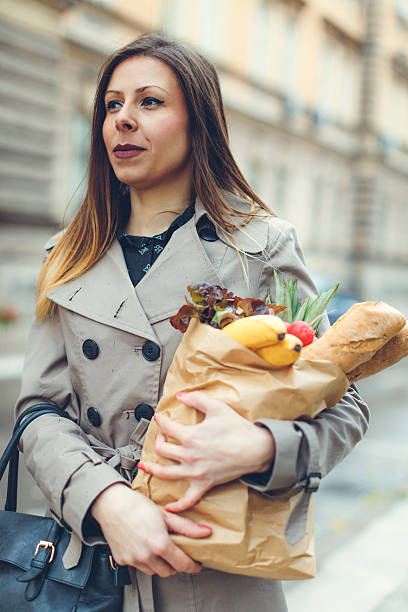 istock Woman carrying groceries 626009830
