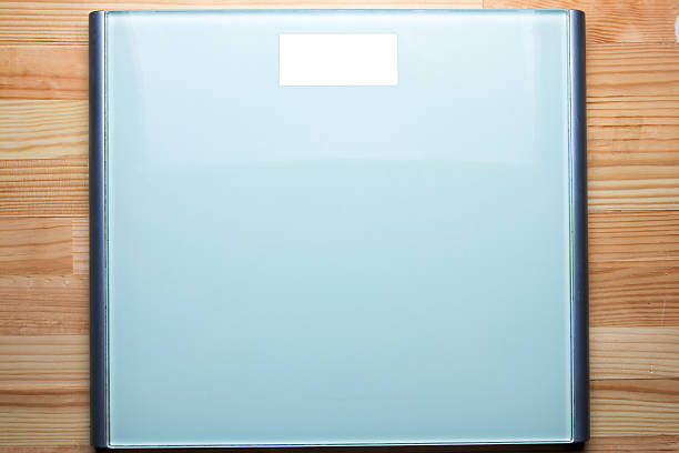 istock Bathroom weight scale on natural wooden table. 626009864