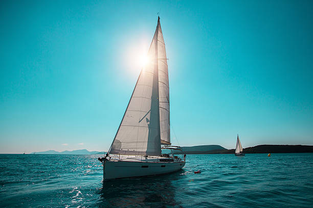 istock Sailing ship yachts with white sails in the open Sea. 626037608