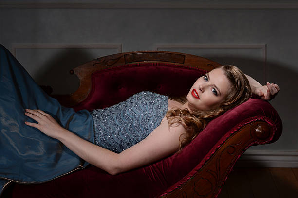 portrait of 1940s style brunette on fainting couch
