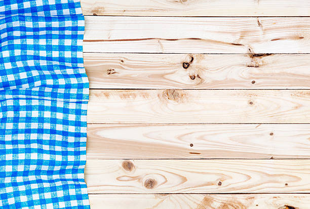 istock Blue tablecloth on wooden table, top view 626045298