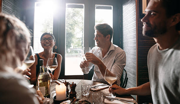 istock Young men and women having wine at restaurant 626055954