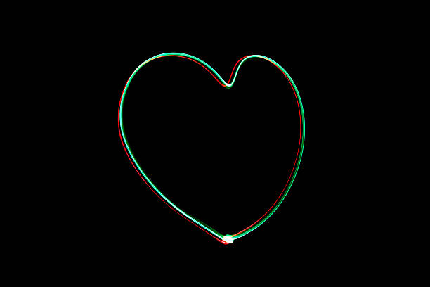 istock Light painting heart shape over black background 626056528