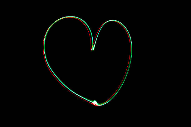 istock Light painting heart shape over black background 626056538