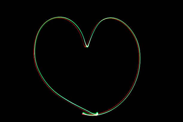 istock Light painting heart shape over black background 626056546