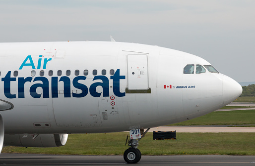 Manchester, United Kingdom - May 8, 2016: Air Transat Airbus A310 wide-body passenger plane (C-GFAT) taxiing on Manchester International Airport tarmac.
