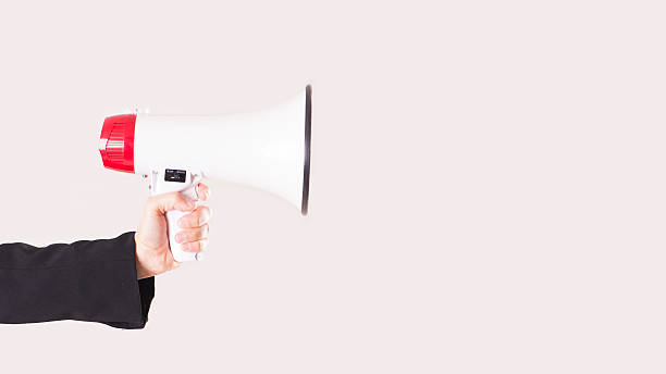 istock Woman holding a white and red megaphone in his hand. 626060580