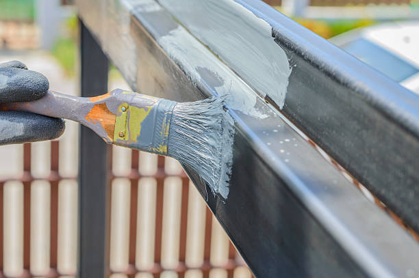 istock hand with paintbrush painting a steel. 626061698
