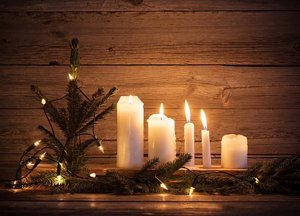 istock Christmas candles on wooden background 626062140