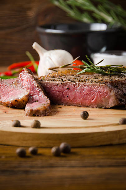 istock rare steak wooden cutting board 626066872