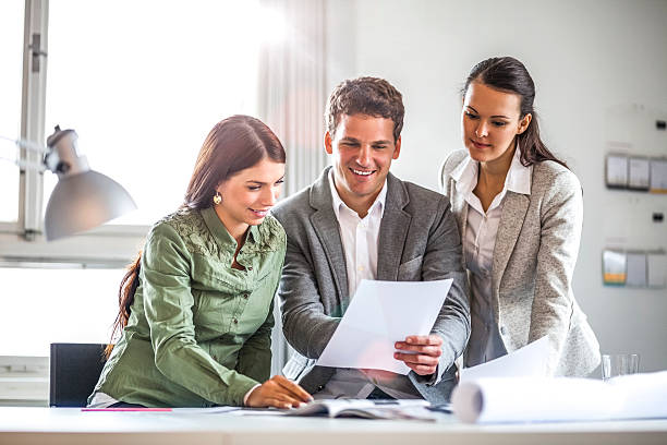 istock Business people reviewing documents in office 626069972