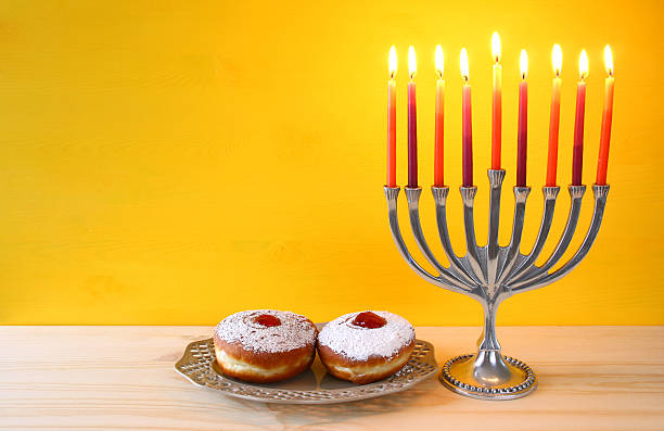 istock jewish holiday Hanukkah with menorah (traditional Candelabra) 626070822