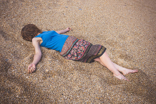 istock Young woman on pebble beach 626073988