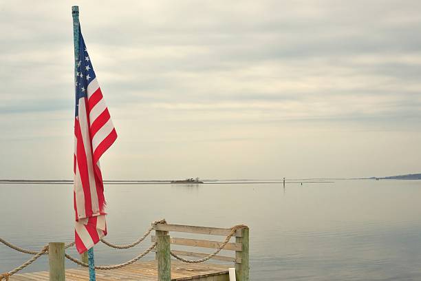 istock American Flag Over Sinepuxent Bay 626074034