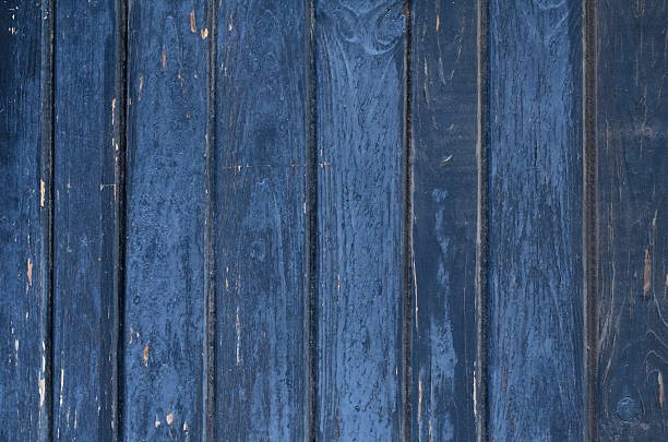 istock Cracked weathered brown painted wooden board texture 626077494