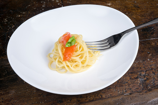 italian spaghetti with tomato and basil in a pot