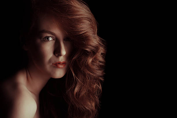 istock Beautiful model with curly hair in the shadows 626078708