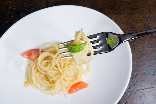 italian spaghetti with tomato and basil in a pot