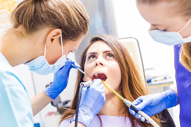 Dental treatment Beautiful woman patient having dental treatment at dentist's office. teeth bonding stock pictures, royalty-free photos & images