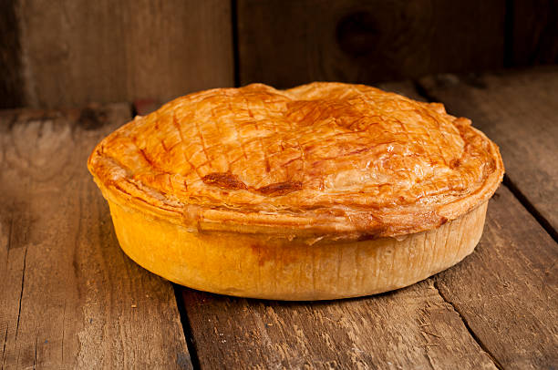 istock Whole Meat Pie on Wooden Surface 626087424