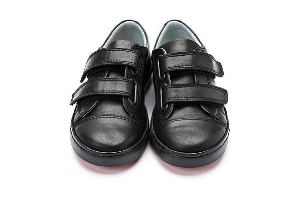 istock Boys black school shoes on a white background 626089450