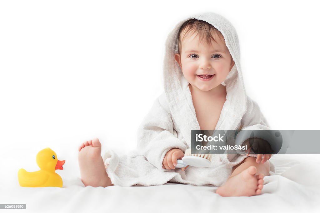 Little baby smiling under a white towel, bath time concept Baby - Human Age Stock Photo