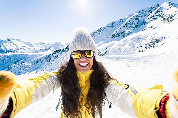 Smiling young woman having fun in the snow