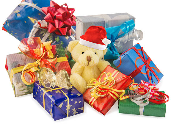 istock Teddy bear with Santa hat and gifts on white. 626095570