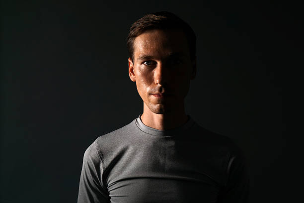 Young man in t-shirt on gray background.