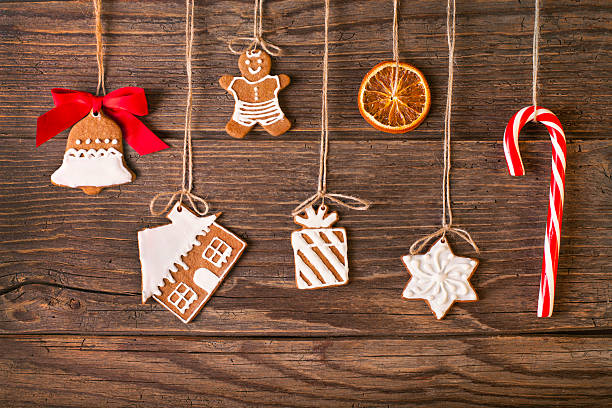 Christmas gingerbread cookies on wood background Christmas gingerbread cookies on wood background. Used gingerbread cookies home-handedly made it from me. They are unique pieces and can not be found anywhere. christmas cookies pattern stock pictures, royalty-free photos & images
