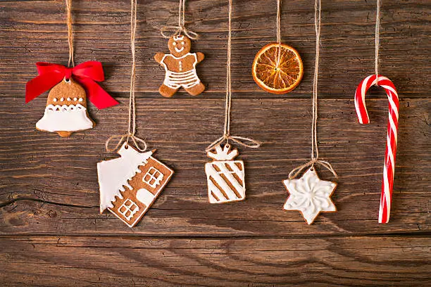 Photo of Christmas gingerbread cookies on wood background