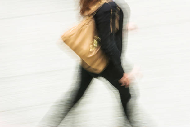 istock woman walking in a street 626099168