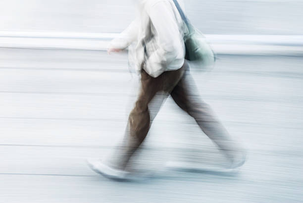 blurry top view of man walking in a street