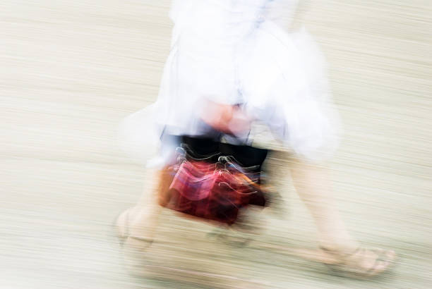 istock woman walking in a street 626099208