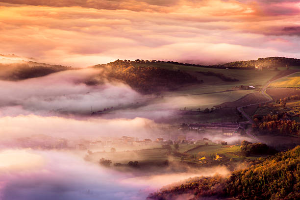 Sunrise with rays over the misty valleys in Tuscany,Italy,Europe,Nikon D850