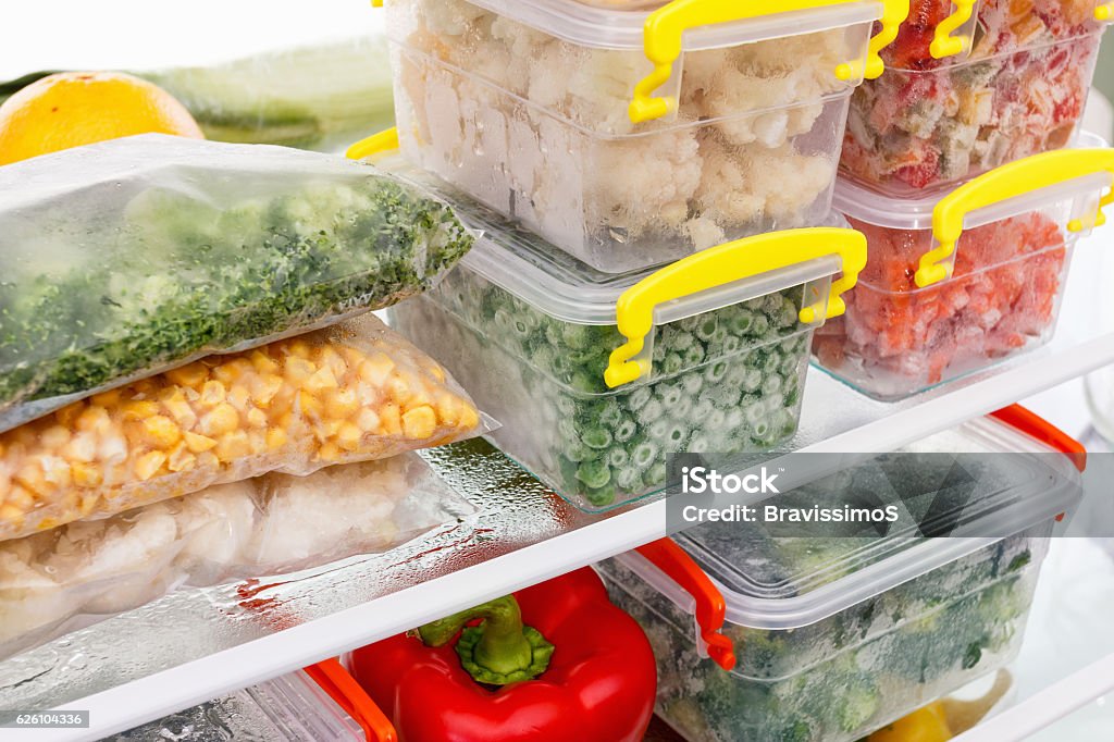 Frozen food in the refrigerator. Vegetables on the freezer shelves. Frozen food in the refrigerator. Vegetables on the freezer shelves. Stocks of meal for the winter. Food Stock Photo
