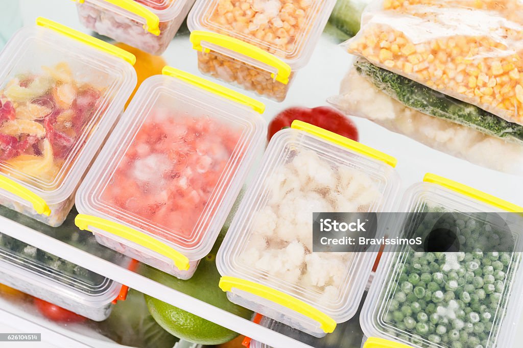 Frozen food in the refrigerator. Vegetables on the freezer shelves. Frozen food in the refrigerator. Vegetables on the freezer shelves. Stocks of meal for the winter. Frozen Food Stock Photo