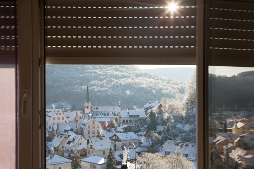 German town on the Neckar River on a cold winter day. View through half-closed roller shutters.
