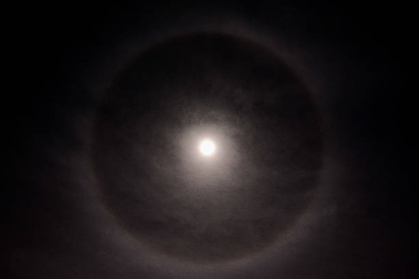 istock Full moon in a cloudy sky with halo 626118500