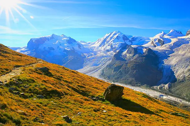 Idyllic Monte Rosa massif, Gorner glacier crevasses dramatic sunrise, Swiss Alps