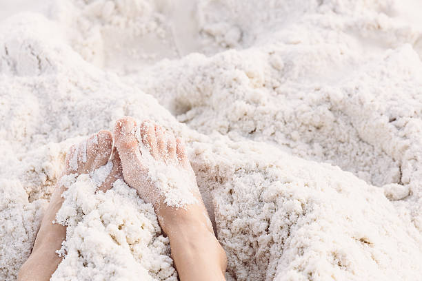 istock Feet in white sand with free space 626133940