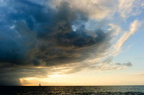 Ocean Sunset Sailboat Storm stock photo