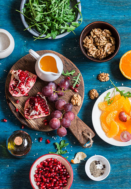 Fresh ingredients for making fruit salad. On blue wooden background, top view. Flat lay