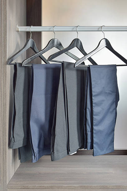 istock row of black pants hangs in wardrobe at home 626144886