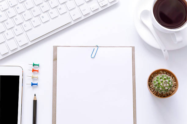 istock Office desk top view with smartphones, flower,coffee cup. 626145146