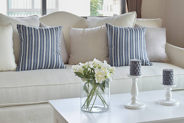 istock blue striped pillows on sofa and decorative flower in vase 626145150